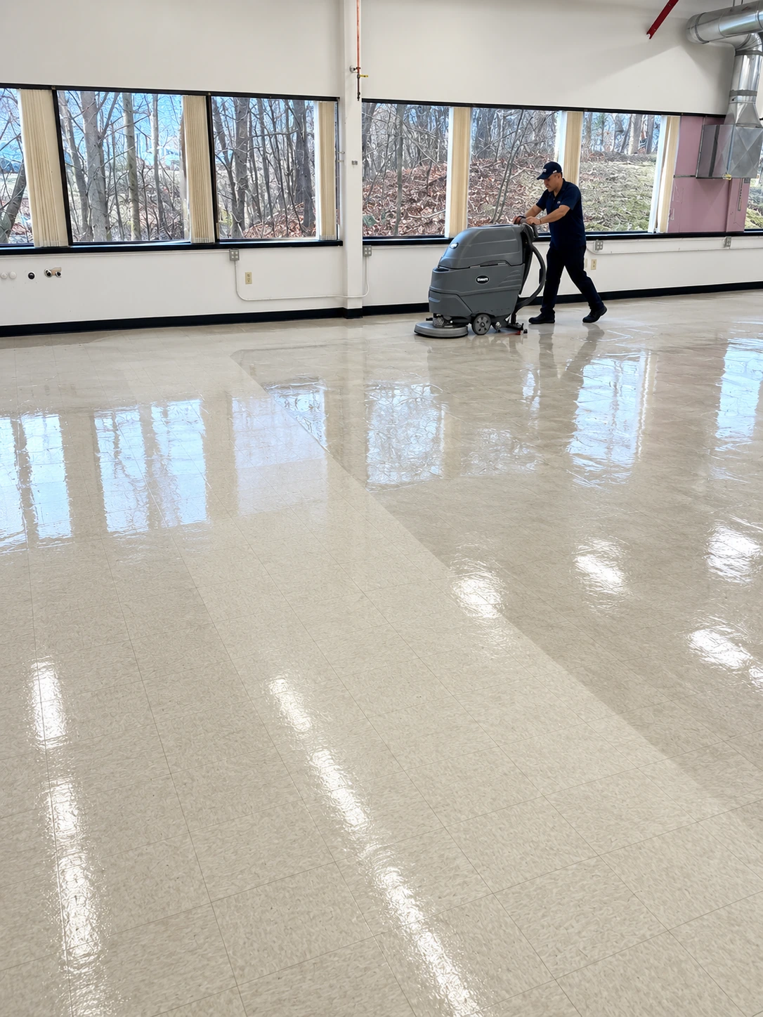 Machine floor scrubbing in progress at a commercial facility.