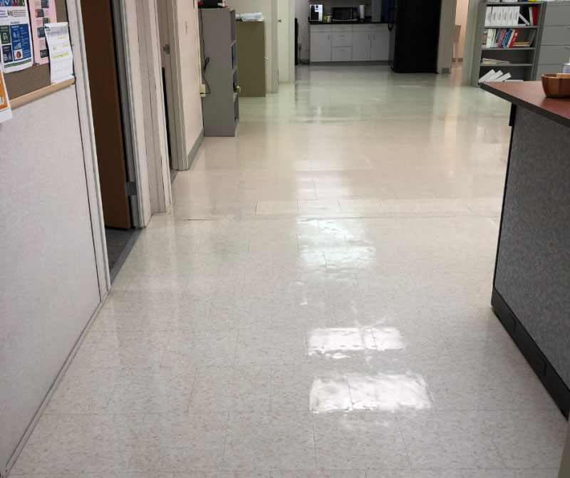 Light tiled floor between office doorways and a reception counter.